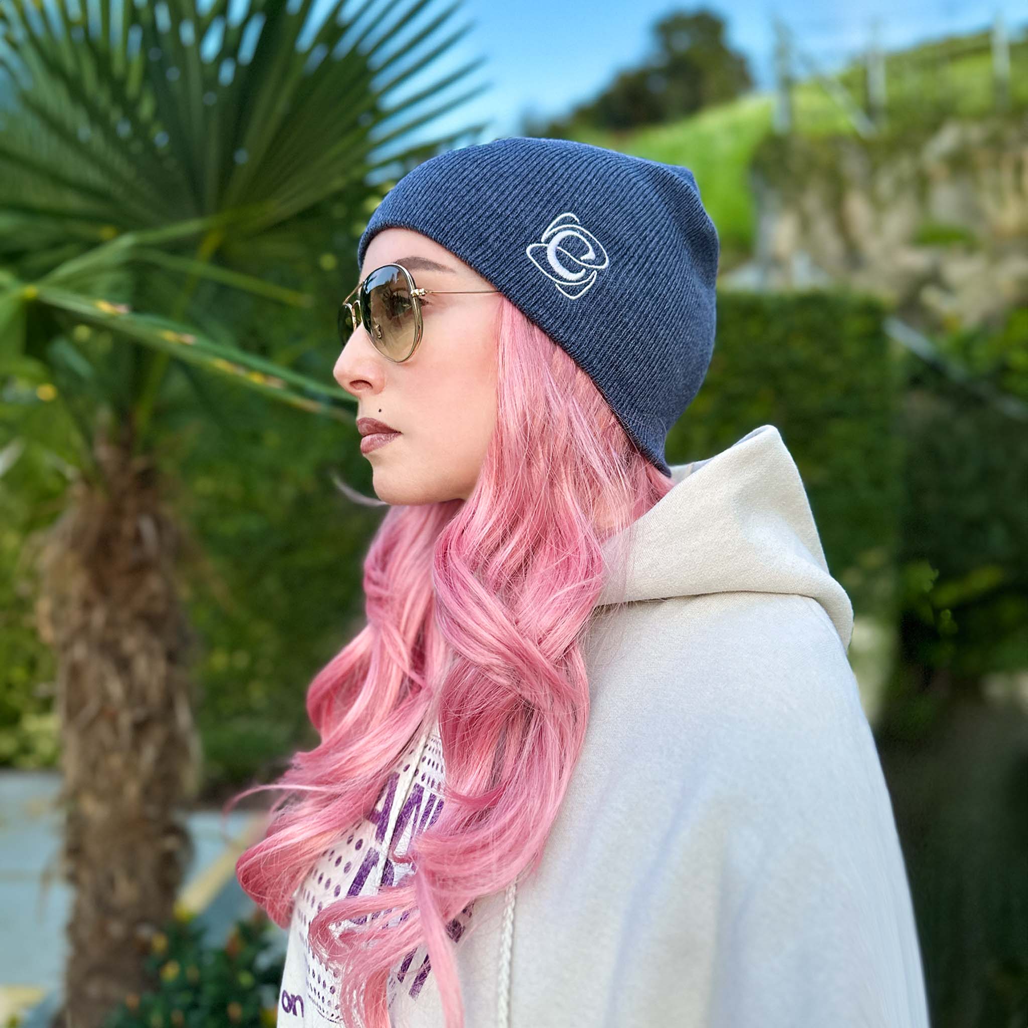 Celleste Heather Navy shorty beanie hat, with white "C" embroidered logo on the left side.