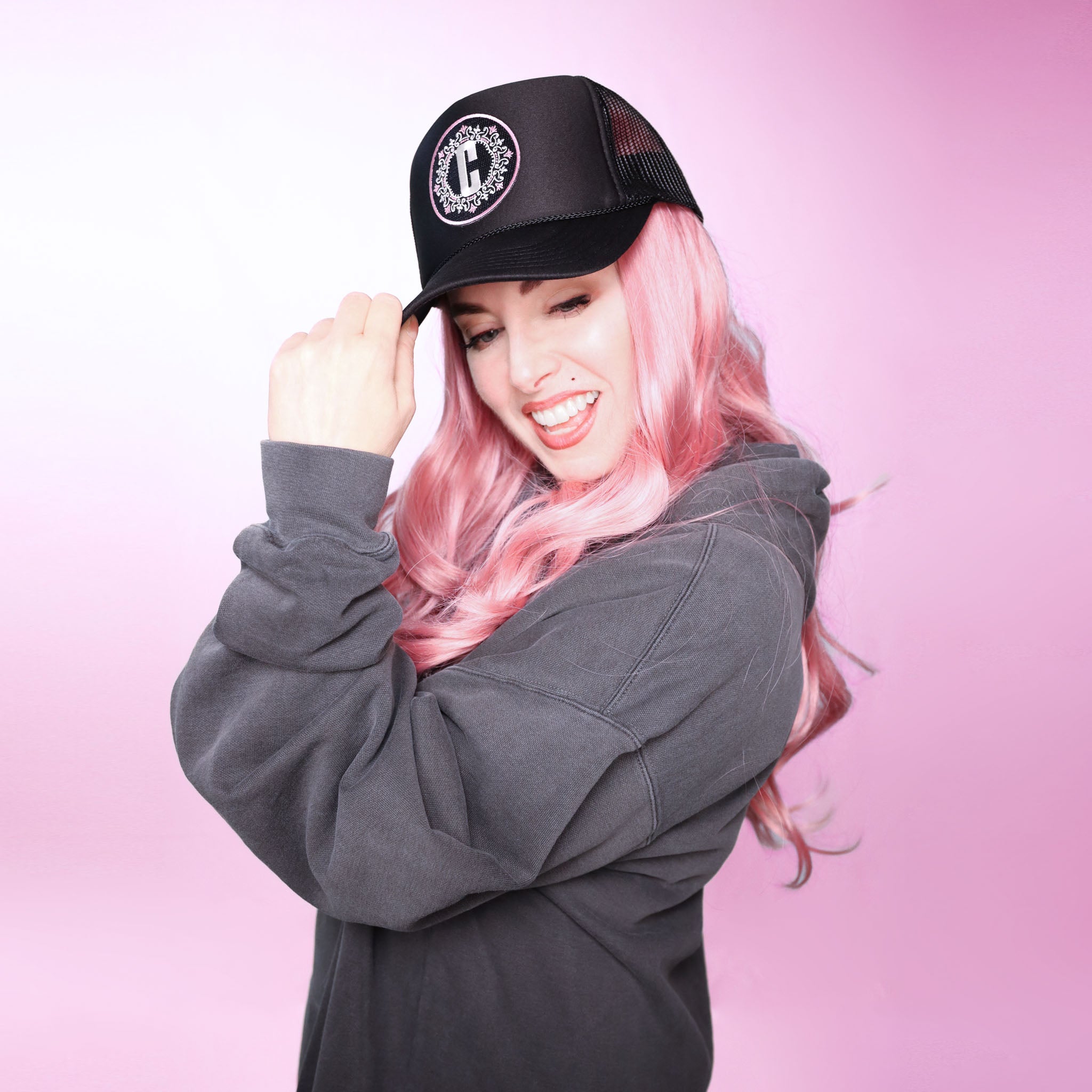 Celleste "C" logo Trucker hat with embroidered black, white and pink patch.