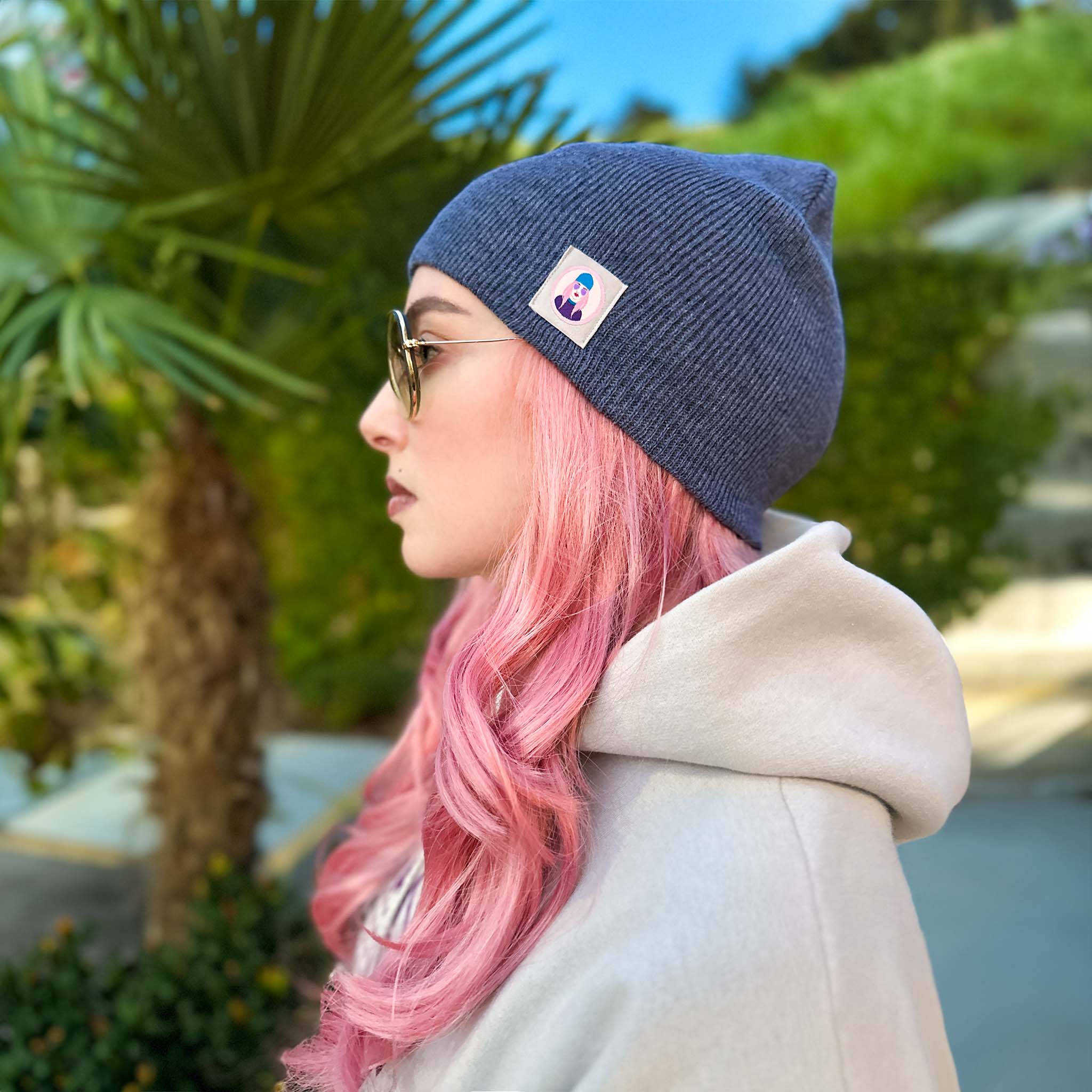 Celleste Heather Navy shorty knit beanie hat, with Signature "Avatar Tag” on the left side. 